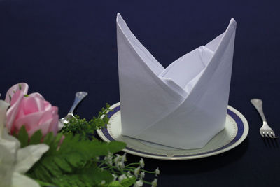 Close-up of white flowers on table against black background