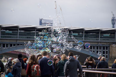 People watching bubbles in city