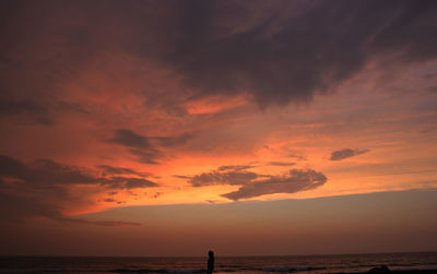 Scenic view of dramatic sky over sea during sunset