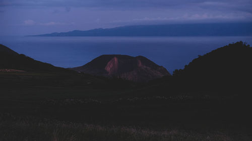 Scenic view of silhouette mountains against sky at dusk