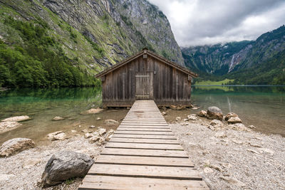 Boardwalk by lake against sky