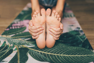 Woman holding her feet while stretching