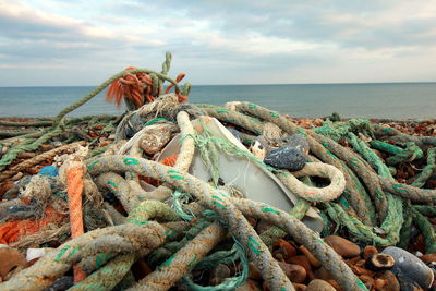 Fishing net on beach against sky