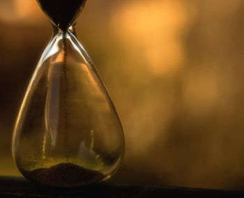 Close-up of clock on sand