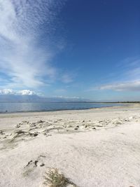 Scenic view of beach against blue sky