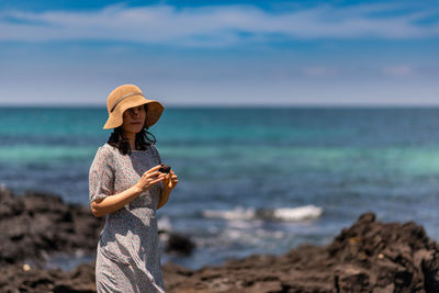 Man holding umbrella on beach