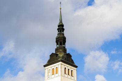 Low angle view of building against cloudy sky