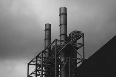 Low angle view of smoke emitting from chimney against sky