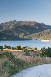 Scenic view of lake and mountains against clear sky