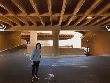 Portrait of woman standing in parking lot