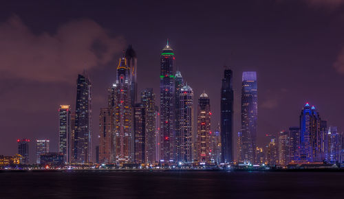 Illuminated cityscape against sky