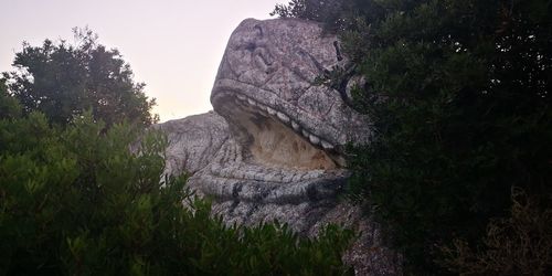 Low angle view of rock formations against sky