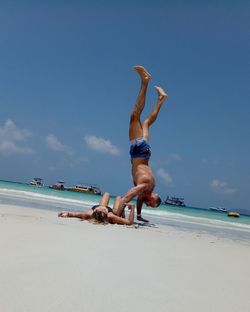 Full length of shirtless man on beach