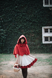 Portrait of young woman standing outdoors