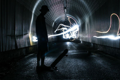 Man in illuminated tunnel