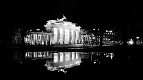 Reflection of building in water at night