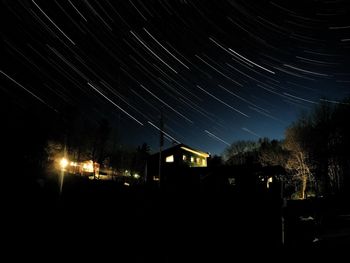 Low angle view of illuminated trees against sky at night