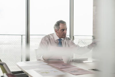 Senior manager in office using futuristic computer