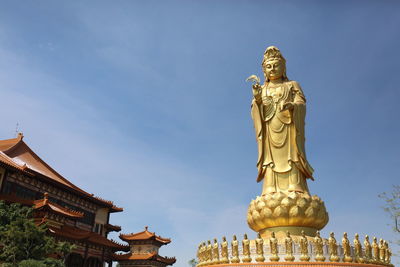 Low angle view of statue of building against sky