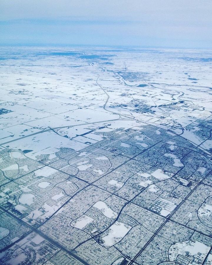 AERIAL VIEW OF SNOW COVERED LANDSCAPE