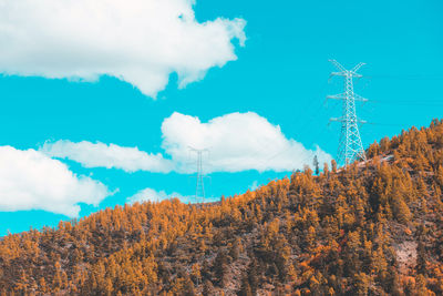 Low angle view of electricity pylon against sky