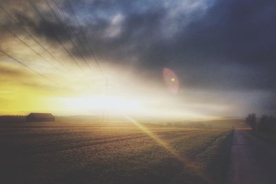 Road against cloudy sky at sunset