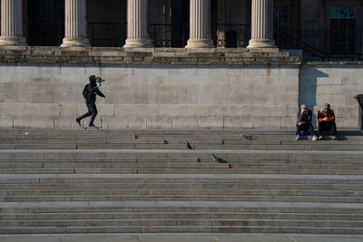 People walking on staircase of building