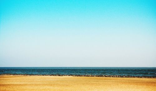 Scenic view of sea against clear blue sky