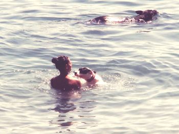 High angle view of people swimming in sea