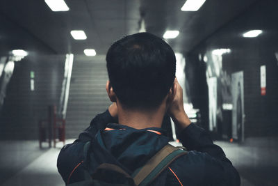 Rear view portrait of man standing in bus