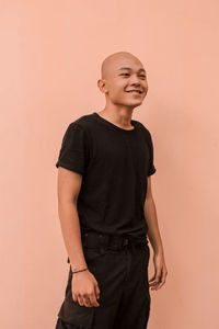 Full length of man looking away against wall