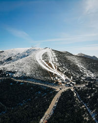 Scenic view of snowcapped mountain against blue sky