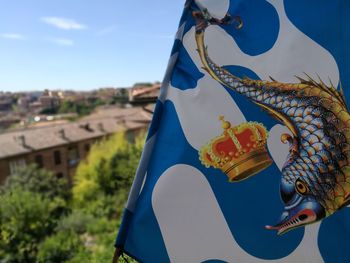 Close-up of umbrella against blue sky