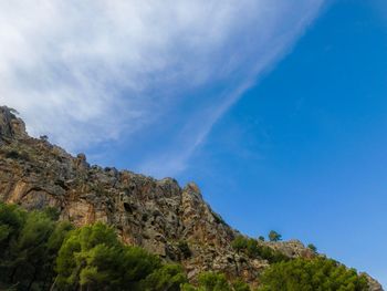 Low angle view of mountain against blue sky