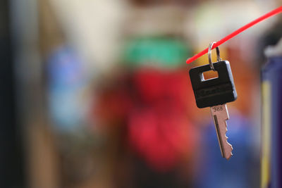 Close-up of toy hanging on cable