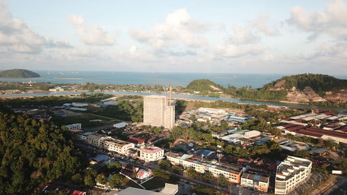 High angle view of townscape by sea against sky