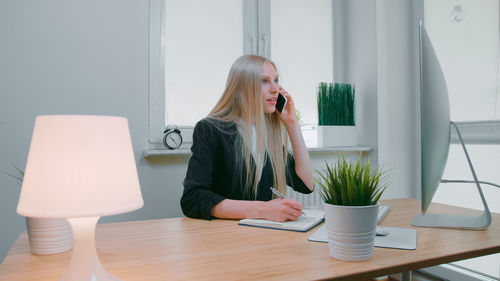 Young woman using laptop on table