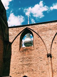 Low angle view of bell tower against sky