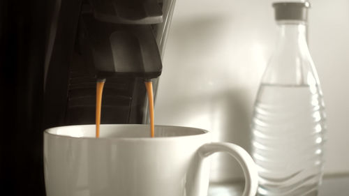 Close-up of coffee pouring from espresso machine