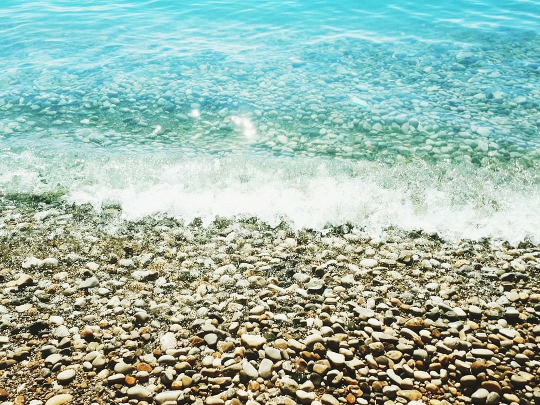 water, sea, beach, beauty in nature, rock, stone, nature, land, pebble, day, no people, solid, scenics - nature, tranquility, stone - object, underwater, wave, outdoors, tranquil scene, undersea, turquoise colored, purity, shallow