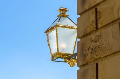 Lamp on a building against clear blue sky