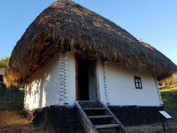 Low angle view of cottage against sky