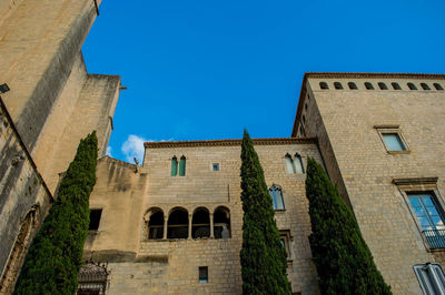 Low angle view of historic building against blue sky