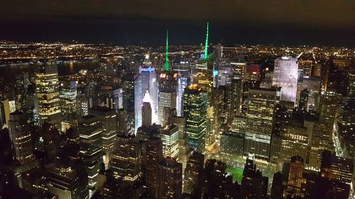 Aerial view of city lit up at night