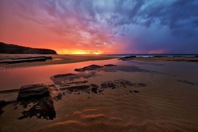 Scenic view of sea against dramatic sky