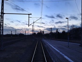 Railroad track against cloudy sky