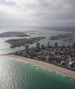 View of cityscape against cloudy sky