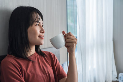 Portrait of woman drinking coffee
