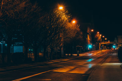 Illuminated city street at night