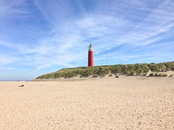 Lighthouse against blue sky at beach